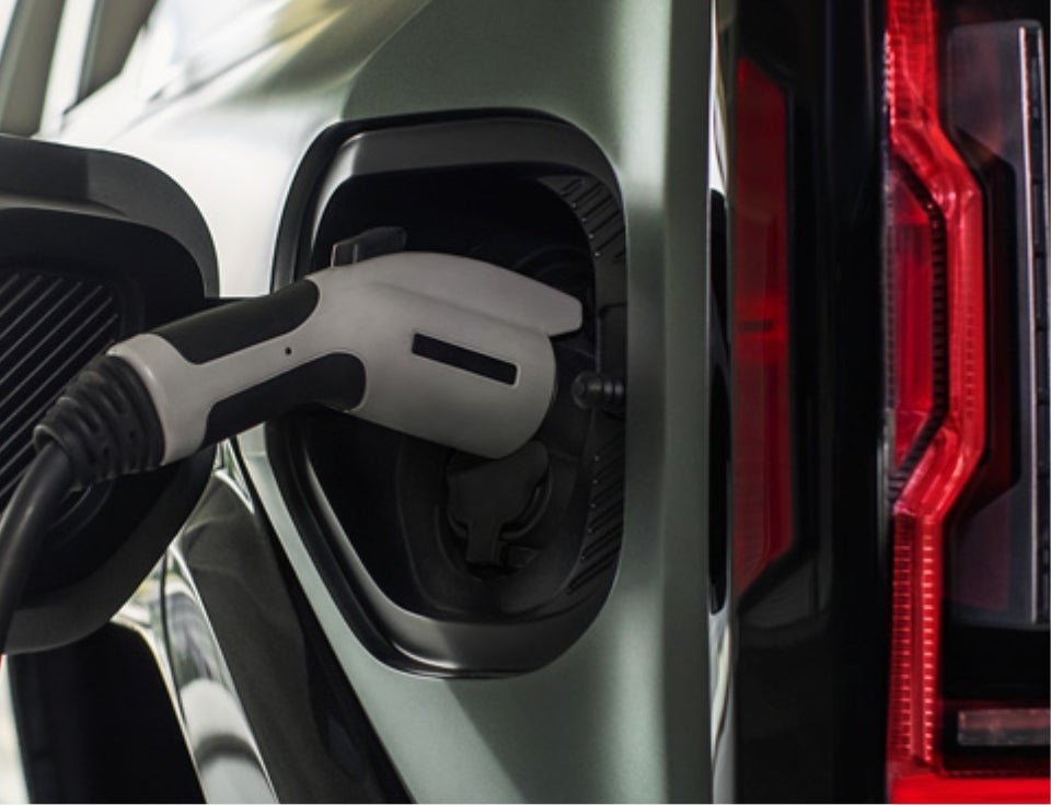 Close up of charging port with charger plugged in on a GMC Hummer EV SUV - Oxendale GMC in FLAGSTAFF AZ